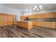 Kitchen with island, wood cabinets, stainless steel refrigerator, and modern lighting at 5217 Cold River Ave, Las Vegas, NV 89130