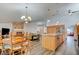 Open-concept kitchen with a center island, wood cabinets, and views of the dining and living areas at 5217 Cold River Ave, Las Vegas, NV 89130