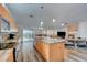 Modern kitchen with sleek cabinets, marble countertops, and stainless steel appliances, open to living space at 5217 Cold River Ave, Las Vegas, NV 89130