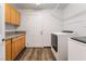 Updated laundry room with plentiful cabinet space, washer, and dryer at 5217 Cold River Ave, Las Vegas, NV 89130