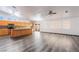 Open living room showcasing wood floors, bright windows, kitchen access, and a ceiling fan at 5217 Cold River Ave, Las Vegas, NV 89130