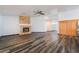 Living room with a stone fireplace and modern wood-look flooring at 5217 Cold River Ave, Las Vegas, NV 89130