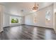 Bright living room with gray flooring, vaulted ceiling, decorative lighting, and natural light at 5217 Cold River Ave, Las Vegas, NV 89130