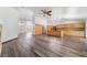 Spacious living room featuring an open floor plan and modern wood-look flooring at 5217 Cold River Ave, Las Vegas, NV 89130