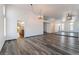 Open-concept living room with grey flooring, light walls, modern lighting fixtures and large wall mirror at 5217 Cold River Ave, Las Vegas, NV 89130