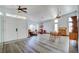 Bright living room with hardwood floors, a decorative chandelier, and ample natural light from large windows at 5217 Cold River Ave, Las Vegas, NV 89130