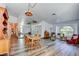 Living room with wood floors, mirrored wall, bright lighting, and access to other rooms at 5217 Cold River Ave, Las Vegas, NV 89130