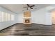 Bright living room with stone fireplace and large windows with plantation shutters at 5217 Cold River Ave, Las Vegas, NV 89130