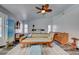 Relaxing main bedroom featuring a cozy chaise lounge, ceiling fan, and shuttered windows at 5217 Cold River Ave, Las Vegas, NV 89130