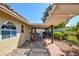 Covered patio area featuring stone flooring and comfortable outdoor seating at 5217 Cold River Ave, Las Vegas, NV 89130