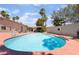 Private swimming pool surrounded by a patio, lush landscaping, palm trees, and a well-maintained lawn at 5217 Cold River Ave, Las Vegas, NV 89130