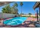 Inviting in-ground swimming pool surrounded by desert landscaping and palm trees, perfect for summer fun at 5217 Cold River Ave, Las Vegas, NV 89130