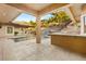 Covered patio overlooking pool with waterfall feature and outdoor kitchen, ideal for entertaining at 540 Regents Gate Dr, Henderson, NV 89012