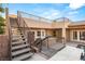 Backyard stairs with steel railings leads to a balcony of modern house overlooking pool and spa at 540 Regents Gate Dr, Henderson, NV 89012
