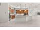 Open kitchen with stainless steel appliances, breakfast bar, and wood cabinets at 540 Regents Gate Dr, Henderson, NV 89012