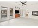 Open-concept living room with a fireplace, TV, and sliding door access to the pool area at 540 Regents Gate Dr, Henderson, NV 89012