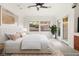 Bright and airy main bedroom featuring neutral tones, ceiling fan, and a window view at 540 Regents Gate Dr, Henderson, NV 89012