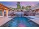 Backyard pool with waterfall feature surrounded by palm trees and lush landscaping at 540 Regents Gate Dr, Henderson, NV 89012