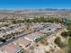 Scenic aerial shot of a desert community with a golf course and mountain range in the background at 5675 E La Campana Dr, Pahrump, NV 89061