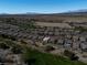 Expansive aerial view of a neighborhood in a desert landscape with mountains in the distance at 5675 E La Campana Dr, Pahrump, NV 89061