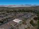 High-angle view of homes nestled in a desert community with golf course and mountain vista at 5675 E La Campana Dr, Pahrump, NV 89061