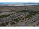Expansive aerial view of a desert community with golf course and mountain backdrop at 5675 E La Campana Dr, Pahrump, NV 89061