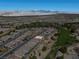 Scenic aerial view of a residential community near a golf course and desert mountains at 5675 E La Campana Dr, Pahrump, NV 89061