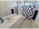 Stylish bathroom features a shower with a checkered curtain and a vanity at 5675 E La Campana Dr, Pahrump, NV 89061