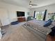 Comfortable bedroom with plush carpet, a ceiling fan, and sliding door to the yard at 5675 E La Campana Dr, Pahrump, NV 89061