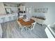 Bright eat-in kitchen area featuring a round wooden table, white cabinets and modern appliances at 5675 E La Campana Dr, Pahrump, NV 89061