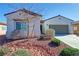 Charming single-story home with desert landscaping, a two-car garage, and white stucco at 5675 E La Campana Dr, Pahrump, NV 89061