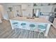 Modern kitchen offers stainless appliances, island with seating, and abundant natural light at 5675 E La Campana Dr, Pahrump, NV 89061