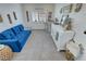 Bright living room with a blue sofa, stylish decor and white console table by the window at 5675 E La Campana Dr, Pahrump, NV 89061