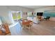 Bright living room with dining area, sliding glass doors, and beachy decor at 5675 E La Campana Dr, Pahrump, NV 89061
