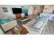 Open living room featuring comfortable sofas, a coffee table, and modern beach-themed decor at 5675 E La Campana Dr, Pahrump, NV 89061
