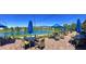 Outdoor patio with dining tables, blue umbrellas, and a scenic lake view at 5675 E La Campana Dr, Pahrump, NV 89061