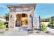 Elegant restaurant entrance with stone archway and beautifully landscaped surroundings at 5675 E La Campana Dr, Pahrump, NV 89061