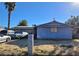 Modest single story home with front yard, covered vehicle, and mature landscaping at 5809 Pebble Beach Blvd, Las Vegas, NV 89108