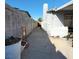 Narrow side yard with concrete pathway, ideal for storage or utilities at 5809 Pebble Beach Blvd, Las Vegas, NV 89108
