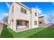 Charming backyard with artificial turf, an extended patio, and privacy fence, perfect for outdoor living at 5832 Sleepy Willow St, Las Vegas, NV 89148