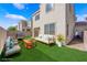 Staged backyard featuring artificial turf, comfortable seating, and a built-in grill, ideal for entertaining guests at 5832 Sleepy Willow St, Las Vegas, NV 89148