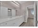 Bright bathroom featuring double sinks, quartz counters, and a large mirror with plenty of storage at 5832 Sleepy Willow St, Las Vegas, NV 89148