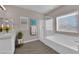 Bright bathroom features a large soaking tub, glass-enclosed shower, and double sink vanity at 5832 Sleepy Willow St, Las Vegas, NV 89148