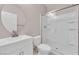 Bright bathroom features a modern vanity with a round mirror and a glass-enclosed shower with built-in shelves at 5832 Sleepy Willow St, Las Vegas, NV 89148