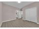Spacious bedroom with wood-look flooring and easy access to the ensuite bathroom at 5832 Sleepy Willow St, Las Vegas, NV 89148