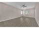 Spacious bedroom featuring sleek hardwood floors, a ceiling fan, and bright, natural light from the windows at 5832 Sleepy Willow St, Las Vegas, NV 89148