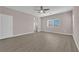 Spacious bedroom with wood-look flooring, bright windows, and a ceiling fan at 5832 Sleepy Willow St, Las Vegas, NV 89148