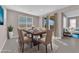 Bright dining area with stylish table set and sliding glass door for natural light at 5832 Sleepy Willow St, Las Vegas, NV 89148
