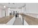 Bright kitchen featuring stainless steel appliances, granite countertops, and a large island with seating at 5832 Sleepy Willow St, Las Vegas, NV 89148