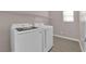 Convenient laundry room featuring a newer washer and dryer set with overhead shelving at 5832 Sleepy Willow St, Las Vegas, NV 89148